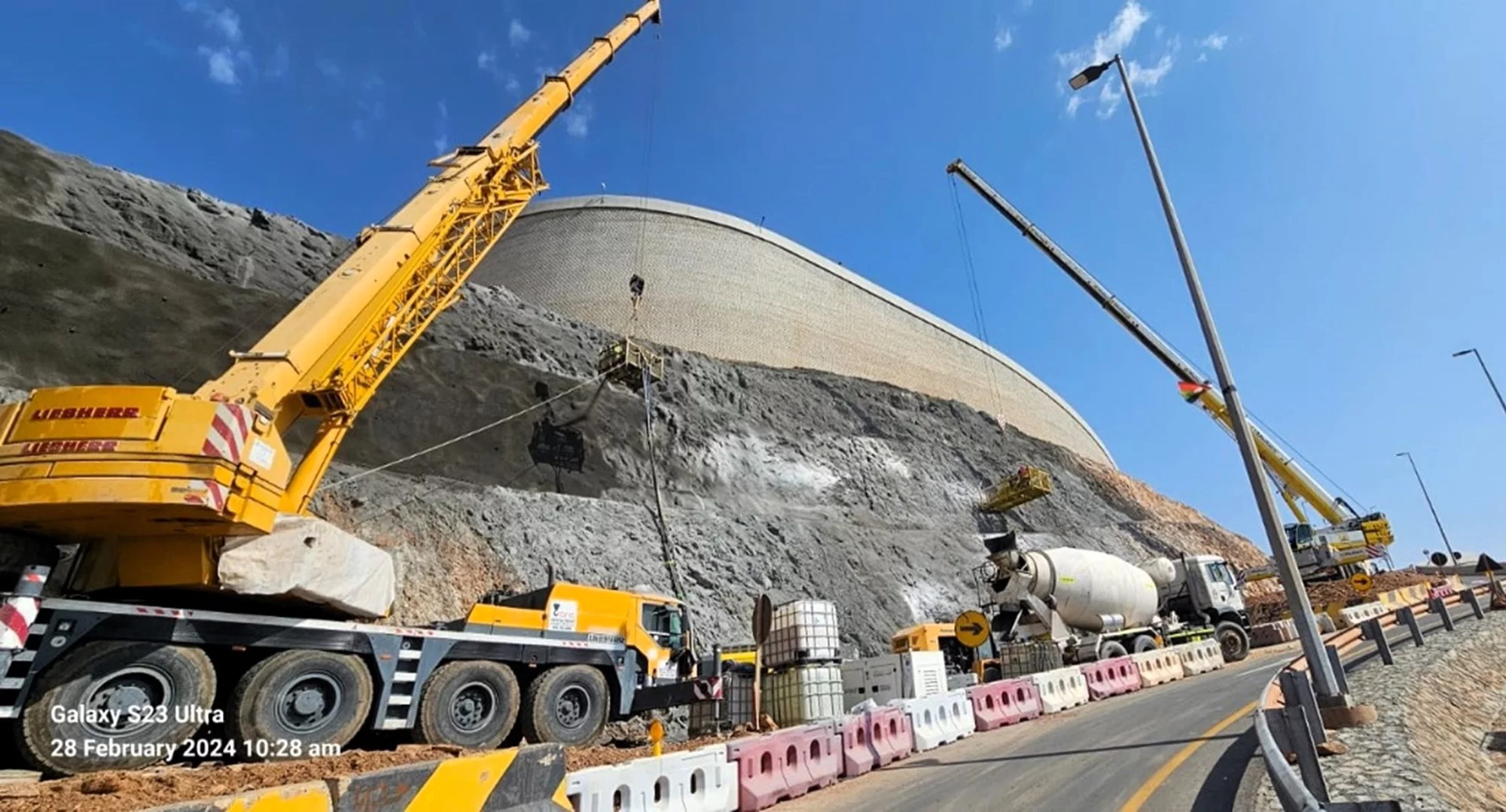 Specialist slope stabilization and shotcreting operations below critical reservoir infrastructure on Mibrih Road